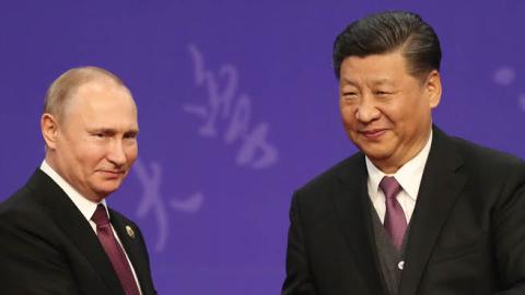 Russian President Vladimir Putin, left, shakes hands with Chinese President Xi Jinping, right, during the Tsinghua Universitys ceremony, at Friendship palace on April 26, 2019 in Beijing, China.