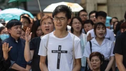 Christian worshippers sing hymns to voice their opposition to an extradition law in Hong Kong, June 14, 2019.