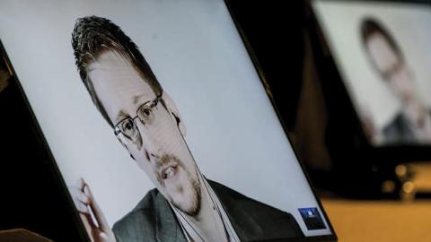 Edward Snowden speaks via video link to participants of the 'MCI alumni and friends' conference at the Congress Innsbruck on October 18, 2018 in Innsbruck, Austria.