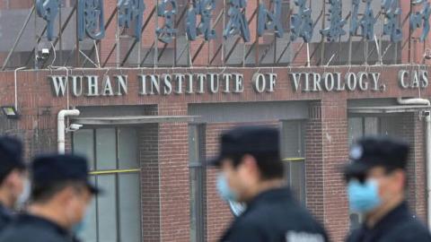 Security personnel stand guard outside the Wuhan Institute of Virology in Wuhan as members of the WHO team investigating the origins of the COVID-19 coronavirus make a visit to the institute in Wuhan