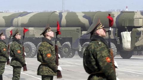 Russian soldiers stand near a Topol-M ICBM while participating in a rehearsal for the nation's Victory Day parade outside Moscow in Alabino on April 22, 2008.