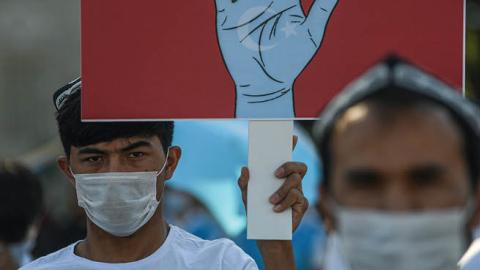 Supporters of China's Muslim Uighur minority wave flags of East Turkestan and hold placards as they gather at the Beyazid square on October 1, 2020 during a demonstration to protest China's Uighur treatment in Istanbul. (Photo by OZAN KOSE/AFP via Getty I