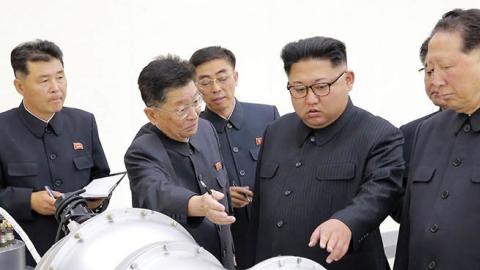 This undated picture released by North Korea's official Korean Central News Agency (KCNA) on September 3, 2017 shows North Korean leader Kim Jong-Un (C) looking at a metal casing with two bulges at an undisclosed location. (STR/AFP via Getty Images)