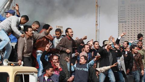 Protestors chant as they ride on an army tank transporter in Tahrir Square on January 29, 2011 in Cairo, Egypt (Photo by Peter Macdiarmid/Getty Images)