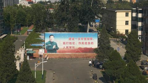 A propaganda billboard depicting Chinese President Xi Jinping in Beijing, China. The sign reads: "We should build a people's army with a good style of work, able to win battles under the command of the Party". (Photo by Andrea Verdelli/Getty Images)