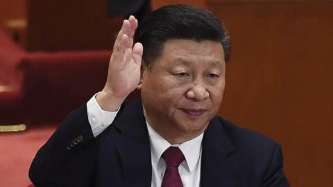 Chinese President Xi Jinping (C) raises his hand to vote for the reports with other China's leaders at the closing of the 19th Communist Party Congress at the Great Hall of the People in Beijing on October 24, 2017 (WANG ZHAO/AFP via Getty Images)