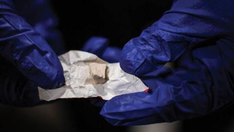 A police offers shows heroine/fentanyl that was part of a kit that a woman was preparing to shoot inside a Walmart's bathroom on Sunday, February 10, 2019, in Manchester, NH. (Salwan Georges/The Washington Post via Getty Images)