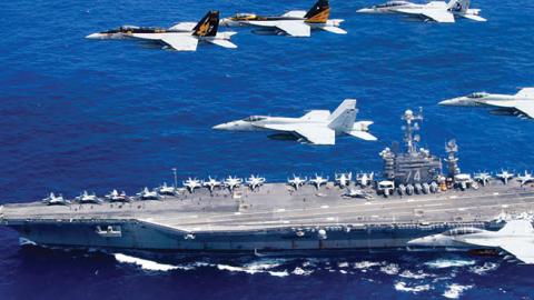 A combined formation of aircraft from Carrier Air Wing (CVW) 5 and Carrier Air Wing (CVW) 9 pass in formation above the Nimitz-class aircraft carrier USS John C. Stennis (CVN 74) (Photo by Lt. Steve Smith/U.S. Navy via Getty Images)