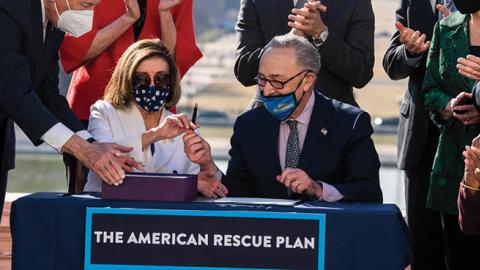 House Majority Leader Steny Hoyer, Speaker of the House Nancy Pelosi, and Senate Majority Leader Chuck Schumer, sign the American Rescue Plan Act on the West Front of the Capitol (Photo By Tom Williams/CQ-Roll Call, Inc via Getty Images)