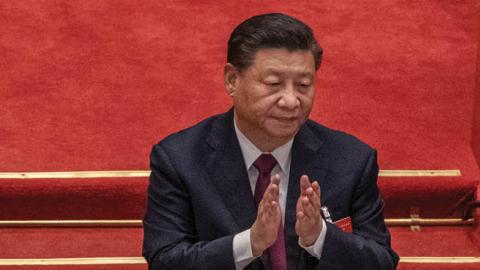 China's President Xi Jinping applauds after voting during a session during the closing session of the National People's Congress (Photo by Kevin Frayer/Getty Images).