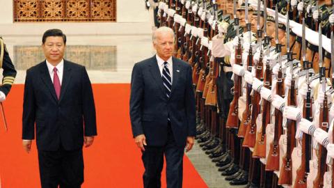 Chinese Vice President Xi Jinping accompanies U.S. Vice President Joe Biden to view an honor guard during a welcoming ceremony inside the Great Hall of the People on August 18, 2011 in Beijing, China (Photo by The Asahi Shimbun via Getty Images)