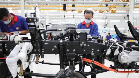 Employees work on production line at a new factory of China's leading new energy vehicle (NEV) manufacturer BYD on July 6, 2020 in Huai'an, Jiangsu Province of China. (Photo by Zhao Qirui/VCG via Getty Images)