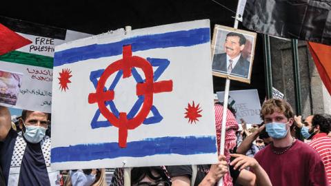People participate in a pro-Palestinian rally on May 22, 2021 in the Queens borough of New York City. After the recent ceasefire between Israelis and Palestinians, activists in New York protested for an end to the Israeli occupation of Palestine. (Photo b