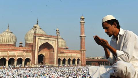 An Indian Muslim devotee offers prayers during Eid al-Adha at Jama Masjid in New Delhi on October 6, 2014 (Photo credit should read Chandan Khanna/AFP via Getty Images)