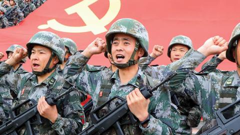 Members of the Communist Party of China (CPC) review the oath of joining the party in front of the party flag on April 13, 2021 in Luoyang, Henan Province of China. (Photo by Jia Fangwen/VCG via Getty Images)