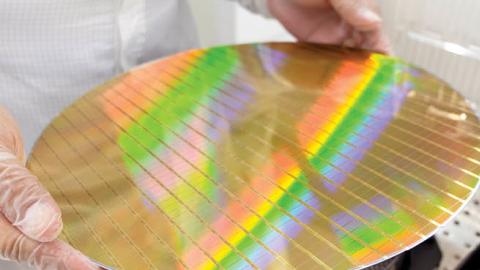 A researcher displays a silicon wafer, an essential material used in the production of semiconductors and other technologies critical to US national security. (Getty Images)