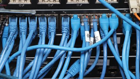 Network cables are plugged in a server room on November 10, 2014 in New York City (Photo by Michael Bocchieri/Getty Images)