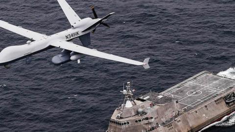 Caption: An MQ-9 Sea Guardian unmanned maritime surveillance aircraft system flies over Independence-variant littoral combat ship USS Coronado. (U.S. Navy)