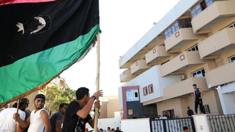 Libyan protesters gather outside the offices of Muslim Brotherhood-backed Party of Justice and Construction, in the Libyan capital Tripoli on July 27, 2013 (MAHMUD TURKIA/AFP via Getty Images)