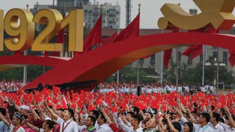 Members of the audience stand and applaud  Xi Jinping during his speech at a ceremony marking the 100th anniversary of the Communist Party at Tiananmen Square on July 1, 2021 (Photo by Kevin Frayer/Getty Images)