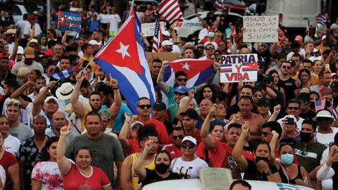 Protesters gather in front of the Versailles restaurant to show support for the people in Cuba who have taken to the streets there to protest on July 11, 2021 in Miami, Florida (Photo by Joe Raedle/Getty Images)