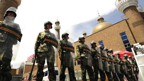 Chinese paramilitary police guard the outside of the Grand Bazaar in the Uighur area in the city of Urumqi in China's Xinjiang region on July 12, 2009 (PETER PARKS/AFP via Getty Images)