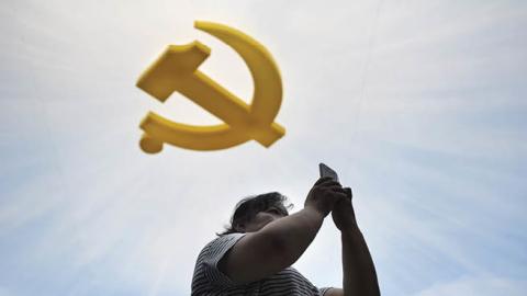 A visitor uses her phone at the Chinese Military Museum in Beijing. (Wang Zhao/AFP via Getty Images)