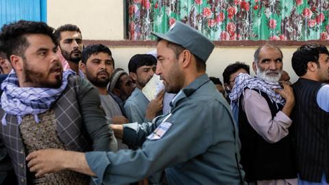Afghans wait in long lines for hours at the passport office as many are desperate to have their travel documents ready to go on August 14, 2021 in Kabul, Afghanistan (Photo by Paula Bronstein /Getty Images)