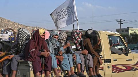 Taliban fighters in a vehicle patrol the streets of Kabul on August 23, 2021 (Photo by WAKIL KOHSAR/AFP via Getty Images)