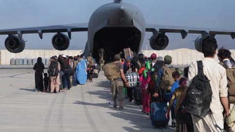 U.S. Air Force loadmasters and pilots load passengers aboard a U.S. Air Force C-17 Globemaster III at Hamid Karzai International Airport (HKIA), Afghanistan, Aug. 24, 2021 (U.S. Air Force photo by Master Sgt. Donald R. Allen)