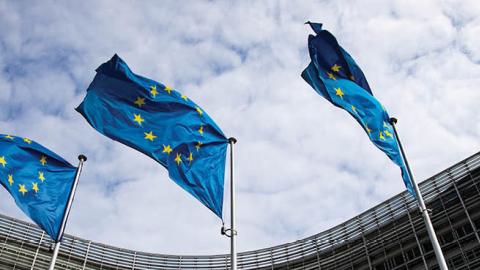 European flags flutter in the wind in front of the Berlaymont building, the seat of the European Commission (Photo by Marcel Kusch/picture alliance via Getty Images)