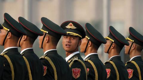 Members of a Chinese honor guard stand in formation before a ceremony to mark Martyr's Day at Tiananmen Square in Beijing, Monday, Sept. 30, 2019. (Photo by Mark Schiefelbein - Pool/Getty Images)
