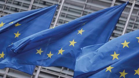 European Union flags fly outside the European Commission building in Brussels, on December 7, 2020. (Photo by Kenzo Tribouillard/AFP via Getty Images)