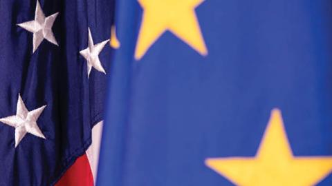 The European Union and United States flags on display. (Photo by Samuel Corum/Getty Images)
