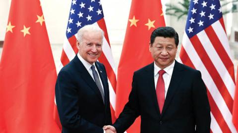 U.S. President Joe Biden shakes hands with Xi Jinping inside the Great Hall of the People on December 4, 2013 in Beijing, China. (Photo by Lintao Zhang/Getty Images)