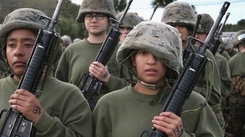 Female Marine recruits stand in formation following hand-to-hand combat training during boot camp February 27, 2013 at MCRD Parris Island, South Carolina. (Photo by Scott Olson/Getty Images)
