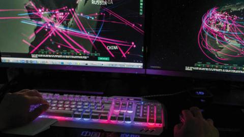 A member of the hacking group Red Hacker Alliance  monitors global cyberattacks on his computer in Dongguan, China. (Photo by NICOLAS ASFOURI/AFP via Getty Images)