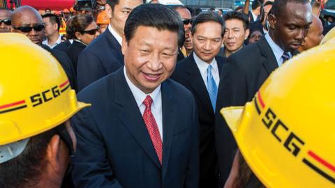 Xi Jinping shakes hands with Chinese workers at a construction site in Port-of-Spain, Trinidad and Tobago, on June 1, 2013. (Frederic Dubray/AFP via Getty Images)