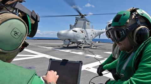 Aviation machinists perform maintenance on a MQ-8B unmanned helicopter on the flight deck of the Independence-variant littoral combat ship USS Gabrielle Giffords (LCS 10), May 14, 2020. (U.S. Navy)