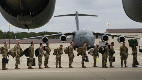 U.S. troops deploy for Europe from Pope Army Airfield at Fort Bragg, North Carolina, on February 3, 2022. (Photo by ALLISON JOYCE/AFP via Getty Images)