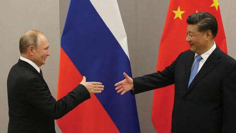 Russian President Vladimir Putin greets Chinese Leader Xi Jinping during their bilateral meeting on November 13, 2019 in Brasilia, Brazil. (Photo by Mikhail Svetlov/Getty Images)
