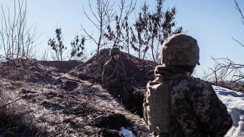 A Ukrainian servicemen stands in a trench at the contact line near the village of Svitlodarsk, in Ukraine's Donestsk region on February 13, 2022. (Photo by Manu Brabo/Getty Images)