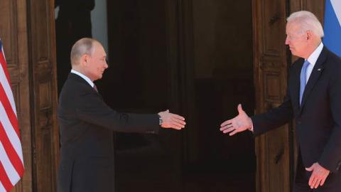 Russian President Vladimir Putin greets U.S. President Joe Biden during the U.S.-Russia Summit 2021 at the La Grange Villa near the Geneva Lake, on June 16, 2021 in Geneva, Switzerland. (Photo by Mikhail Svetlov/Getty Images)