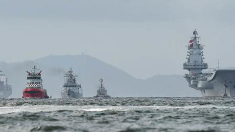 China's sole aircraft carrier, the Liaoning (R), arrives in Hong Kong waters on July 7, 2017. (Anthony Wallace/AFP via Getty Images)