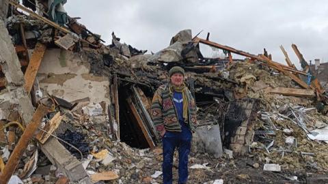 A Ukrainian man stands in the rubble in Zhytomyr on March 02, 2022, following a Russian bombing the day before. (Photo by Emmanuel Duparcq/AFP via Getty Images)
