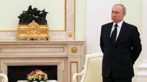 Russian President Vladimir Putin stands in a hall before a meeting with his Belarus counterpart at the Kremlin in Moscow on March 11, 2022. (Getty Images)