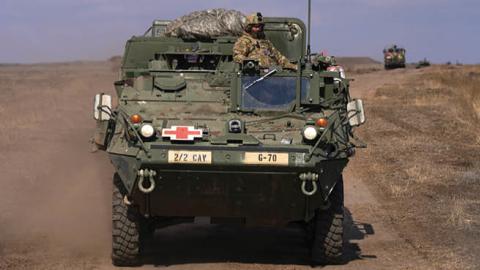 A U.S. soldier on a Stryker takes part in a joint Romanian-U.S. military drill, in a military base, on March 10, 2022, in Smardan, Romania. (Getty Images)