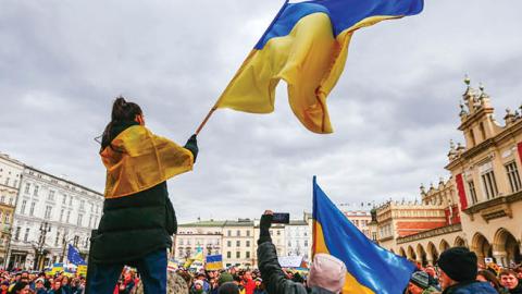 A protester is seen waving a Ukrainian flag during a demonstration in Krakow, Poland on February 27, 2022. (Getty Images)