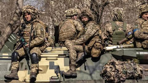Ukrainian soldiers sit on a armored military vehicle in the city of Severodonetsk, Donbas region, on April 7, 2022. (Photo by Fadel Senna/AFP via Getty Images)