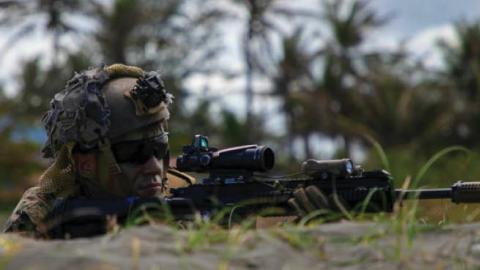 A Marine simulates providing security for an amphibious landing in Appari, Philippines, March 28, 2022, during Balikatan, a bilateral exercise between the U.S. and Philippines. (Photo by United States Marine Corps)